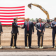 U.S. President Donald Trump (C) shakes hanks with Wisconsin Gov. Scott Walker at the groundbreaking of the Foxconn Technology Group computer screen plant on June 28, 2018 in Mt Pleasant, Wis.